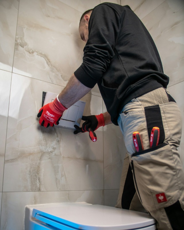 Tom Marsh fitting a replacement boiler in a customer's kitchen